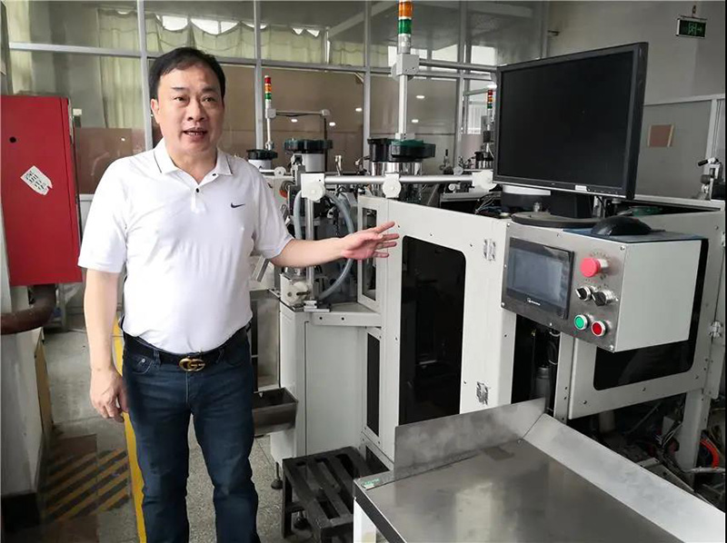 华圣达董事长黄诗华在介绍即将投入使用的自主研发的全自动智能生产拉链机械设备